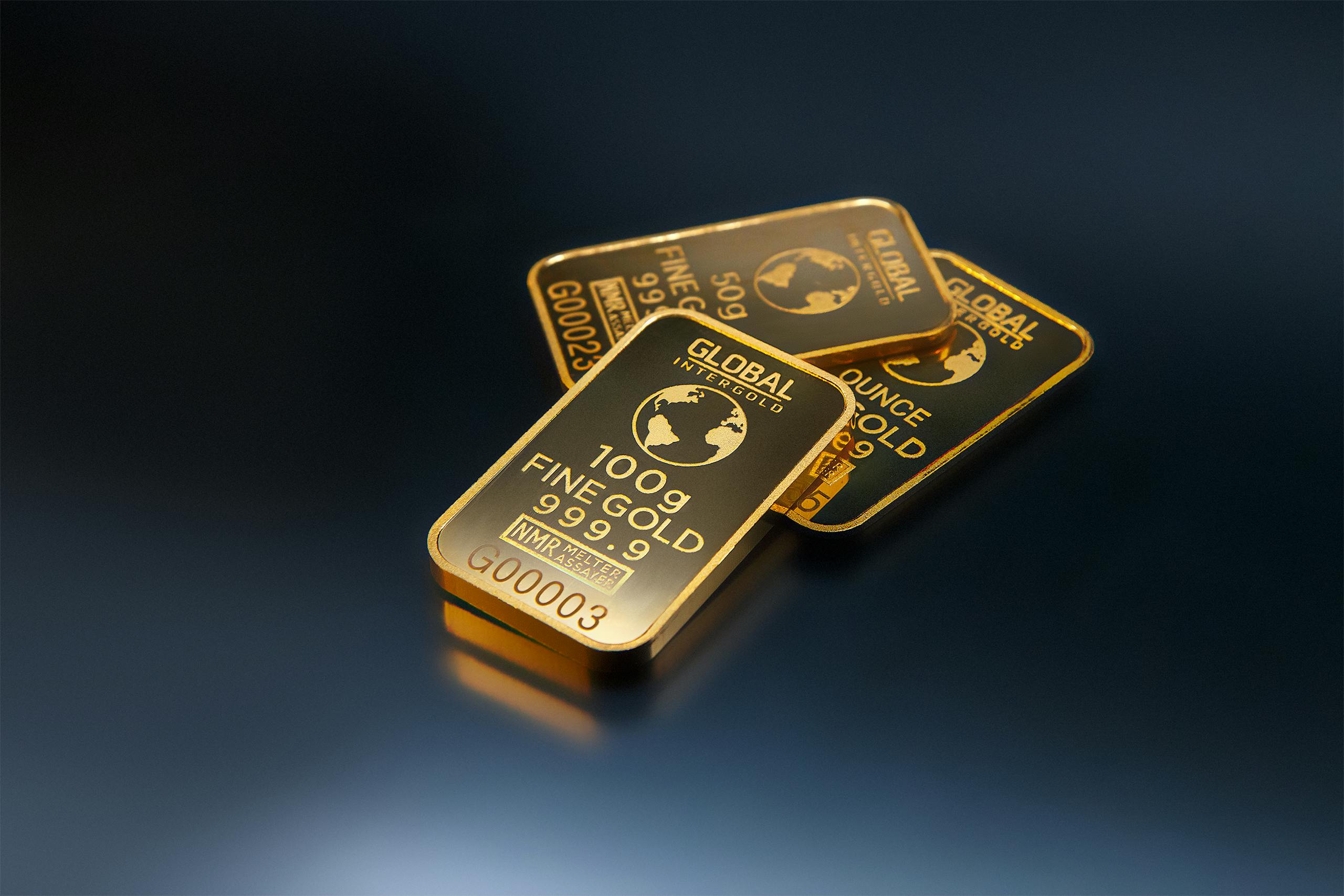 Photo by Michael Steinberg Close-up of gold bars on a dark background, representing wealth and investment opportunities.