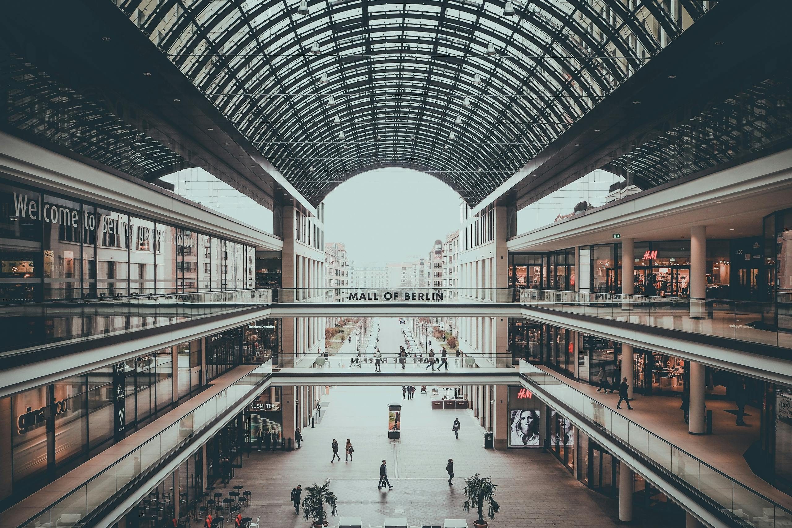 Photo by Pixabay Explore the sleek and multi-level design of Mall of Berlin, showcasing modern architecture and shoppers.